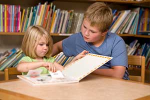Siblings are able to step away from the medical setting and enjoy a quiet moment reading together.