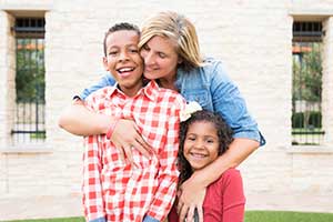 Ronald McDonald House A mother embraces her children, identifying herself as their source of strength in the journey.